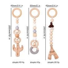 Set of three wooden baby teethers with size details for safe hanging play and teething comfort.
