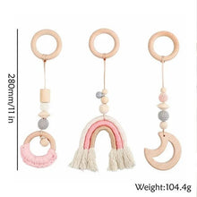 Wooden baby teethers with beads and tassels for grasping practice and colourful gym play.