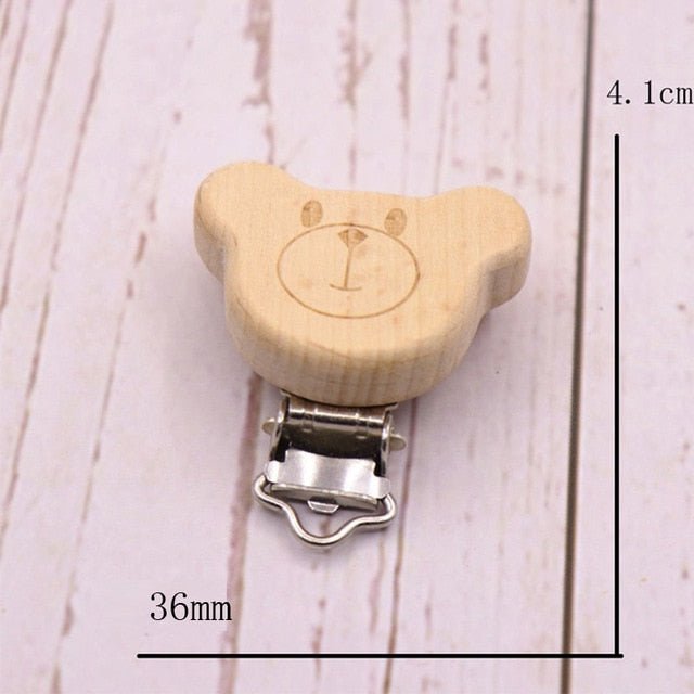 Wooden bear head pacifier clip with metal clasp, a sanded beech teether holder for gentle chewing and soother storage.