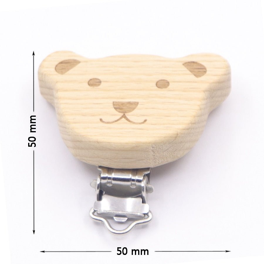 Wooden bear shaped teether with metal pacifier clasp and sizing, a soothing chew accessory for teething infants.