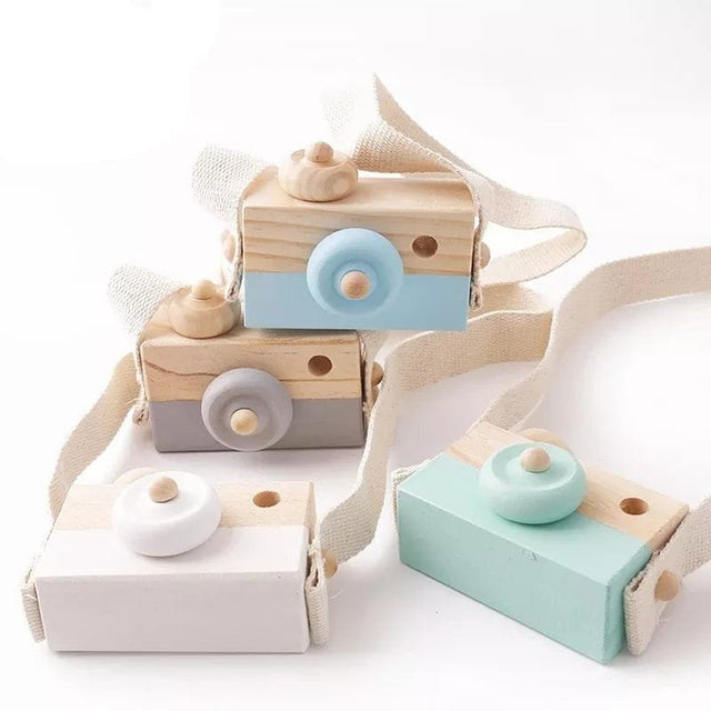 Wooden toy camera with a strap.