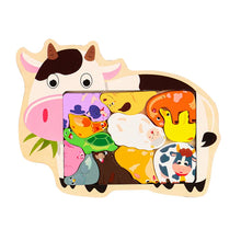 Cow-shaped wooden jigsaw puzzle with colorful animal pieces in the window