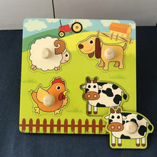 Wooden farm animal puzzle for toddlers practising shape sorting and animal recognition.