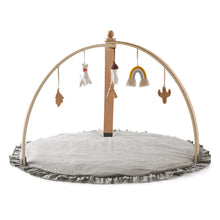 Wooden infant play gym with hanging mobile toys for reaching, batting, and grasping practice on the mat.