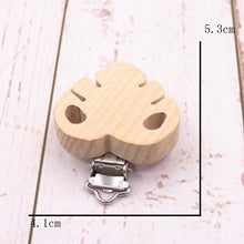 Wooden leaf shaped pacifier clip with metal clasp, a natural teether holder for everyday soothing and family outings.