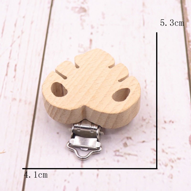 Wooden leaf shaped pacifier clip with metal clasp, a natural teether holder for everyday soothing and family outings.