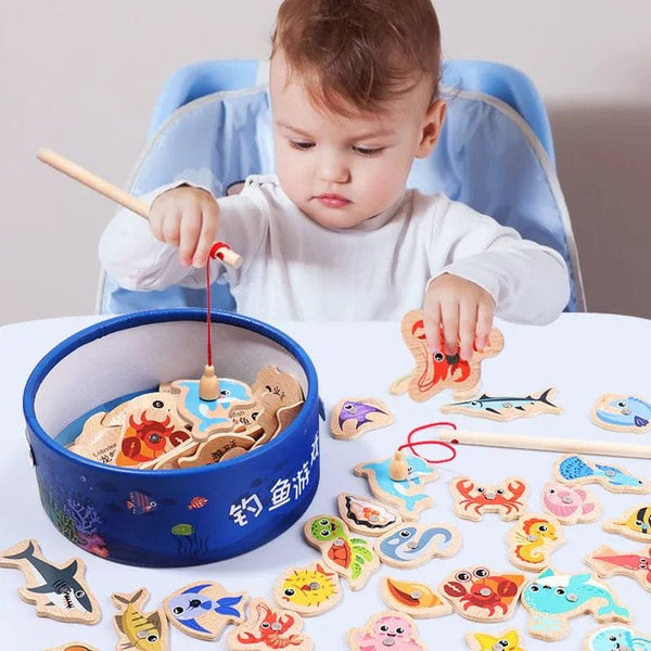 Child playing the wooden Montessori magnetic fishing game at a table, a marine life toy for coordination and focus.