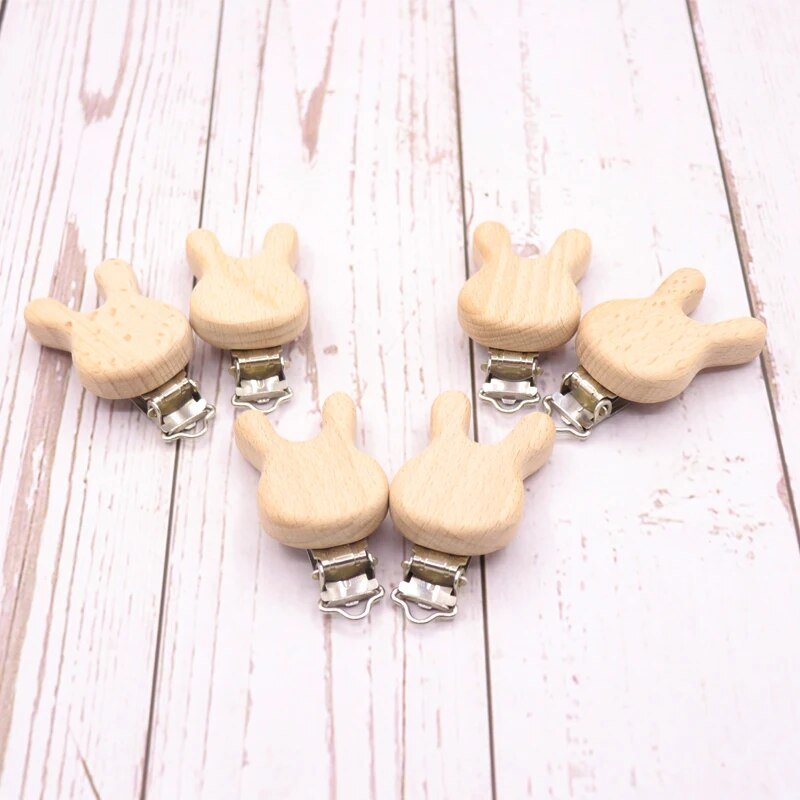 Set of wooden peace sign pacifier clips, natural teether holders for securing dummies during play and travel.