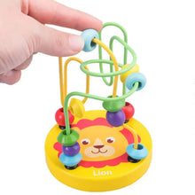 Finger sliding a bead along the wire track of a yellow lion bead maze toy