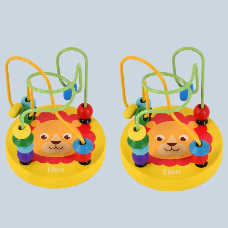 Two yellow lion bead maze toys with green and yellow wire tracks on a gray-blue background