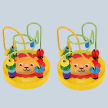 Two yellow lion bead maze toys with green and yellow wire tracks on a gray-blue background