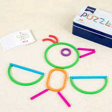 Bird built from green, orange, blue and pink sticks and rings next to a Bird card and the iron box