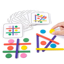 Hand placing a yellow disc next to pattern cards, colorful sticks and round discs