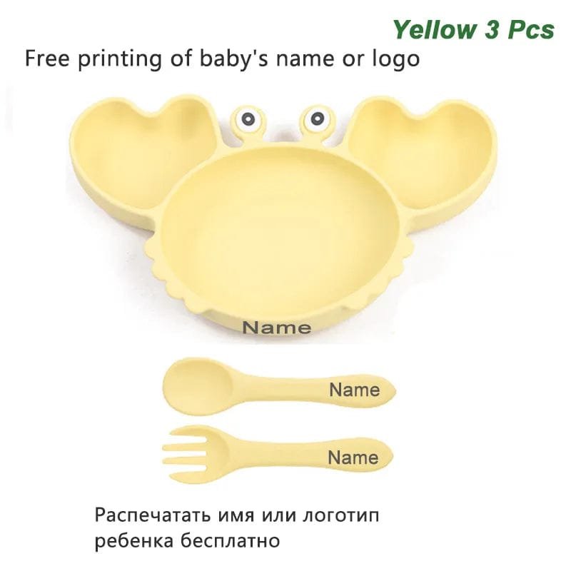 Yellow crab shaped baby plate with spoon and fork, a cheerful set for toddler mealtimes and snack times.