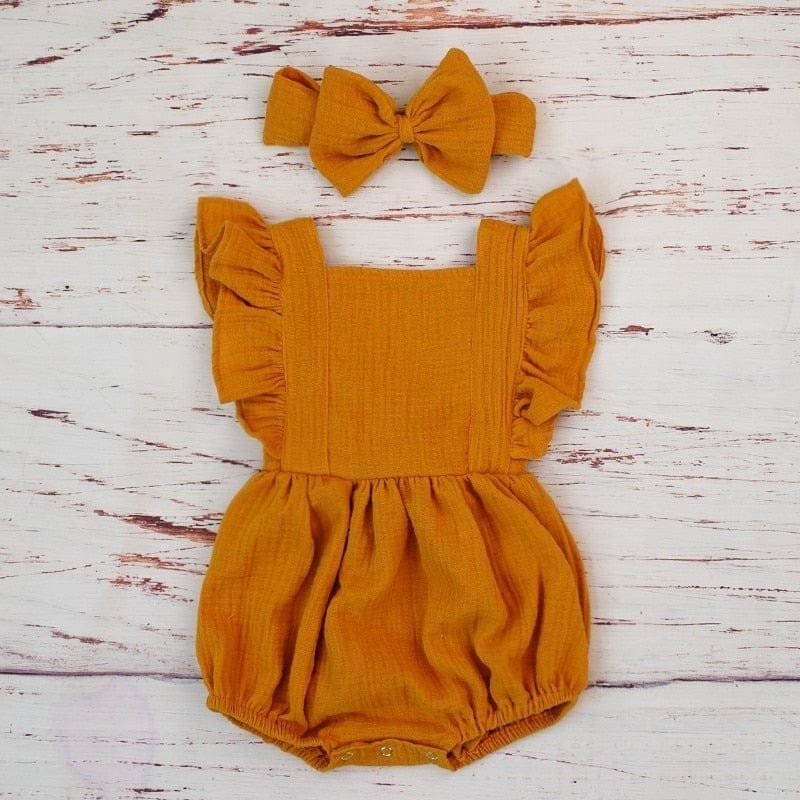Mustard yellow baby girl ruffle romper and headband flat lay, a soft organic cotton set for everyday dressing.