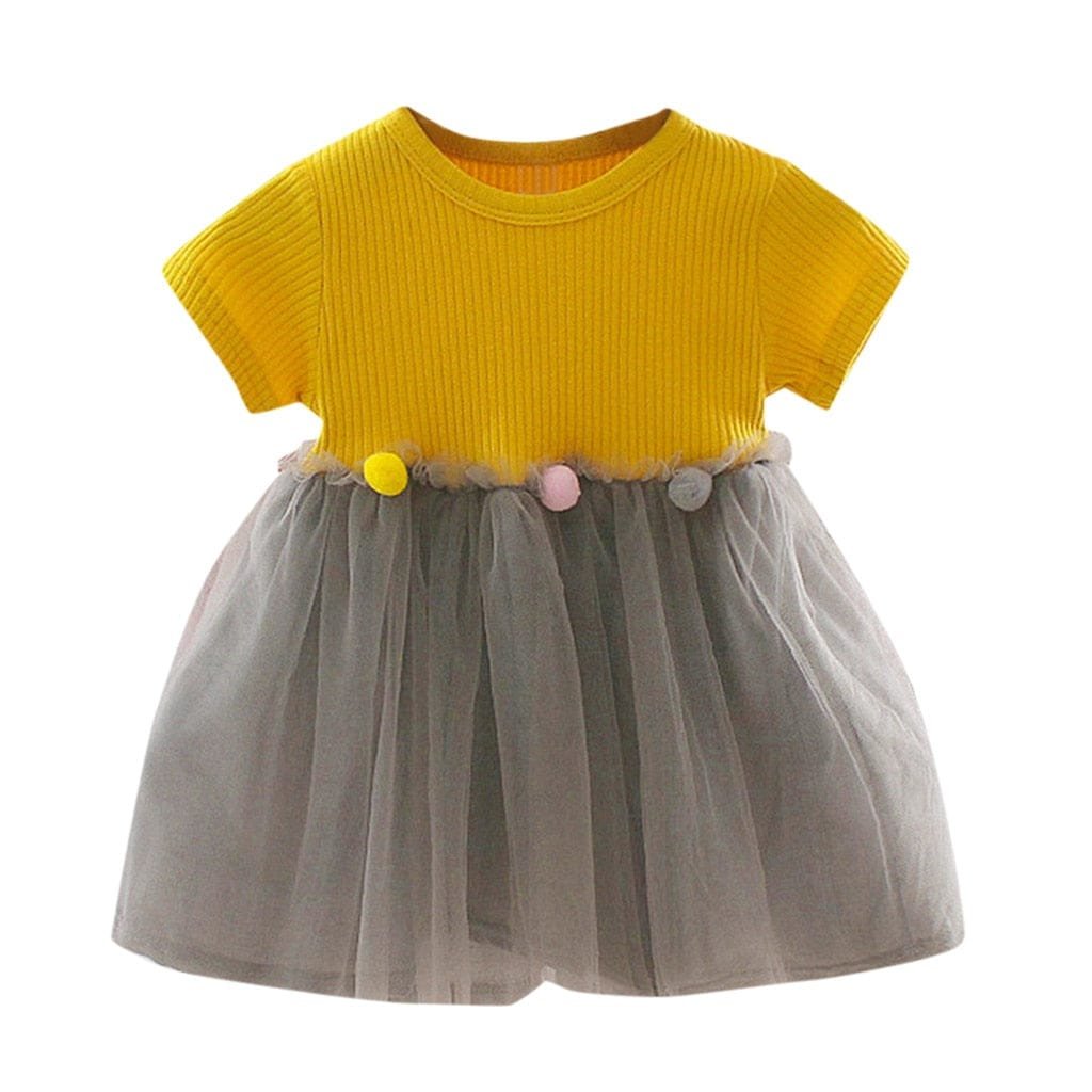 Yellow top and tulle skirt girls dress flat lay for outfit planning ahead of parties and family gatherings.